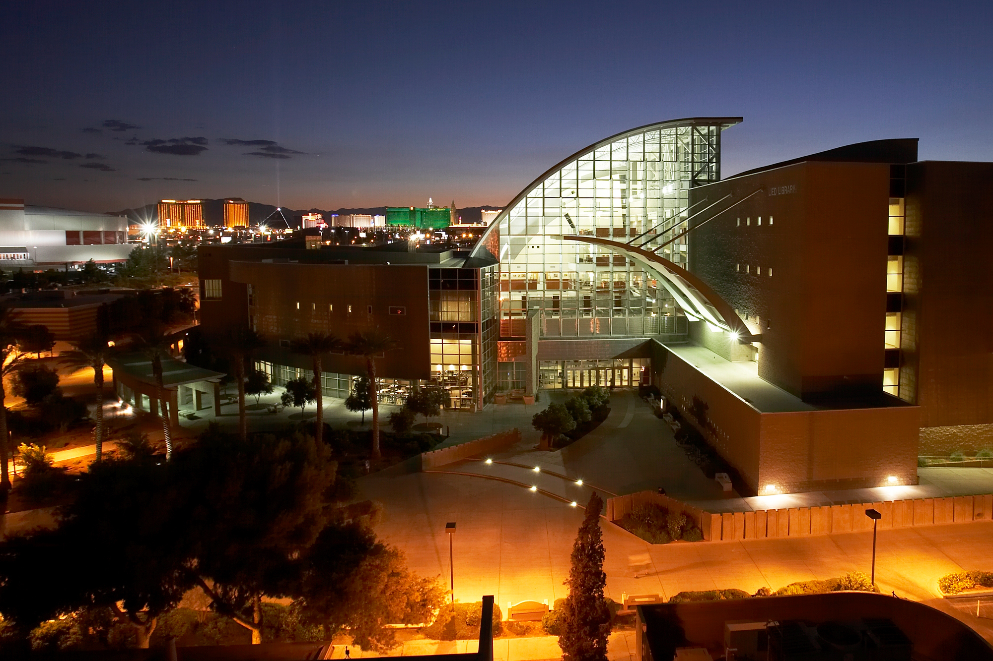 Night time shot of Lied Library, with Las Vegas Strip in background.